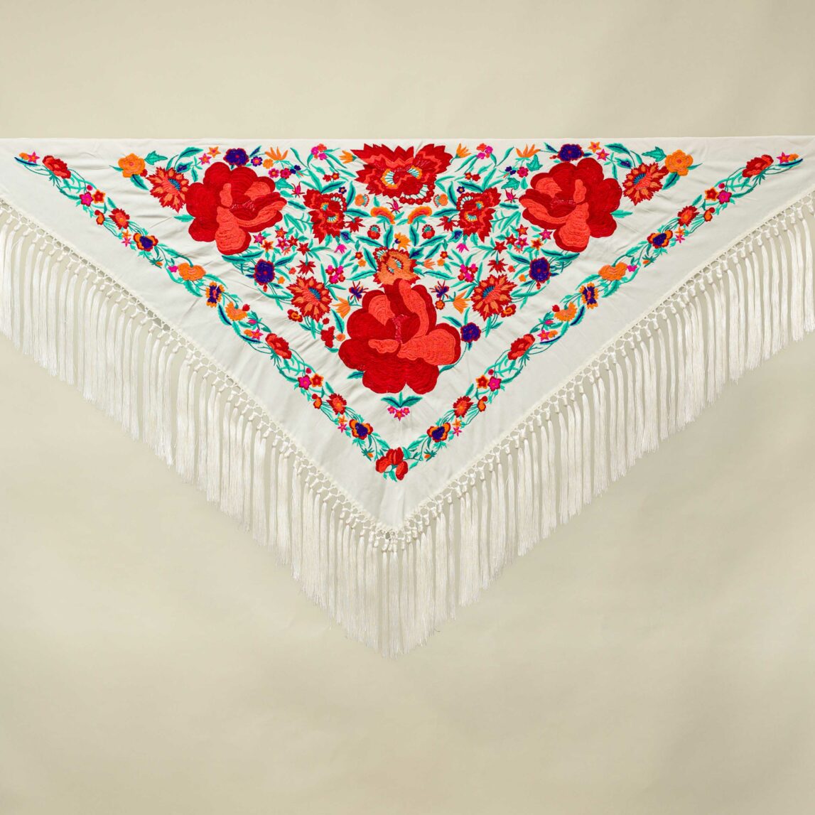 El mantoncillo Fandango crudo es perfecto para cualquier look flamenco 2024. Un mantoncillo crudo bordado en seda con colores y fleco de borlón.