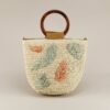 Bolso bucket de fibra natural Green con hojas bordadas en verde y terracota. Diseño artesanal con asas de carey y bandolera . Ideal para looks de verano.